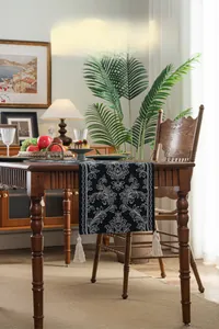 Detail of New Chinese style black jacquard table runner with white scrolls and fringe