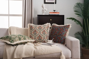 Detail of American style jacquard cushion covers with fringe tassels on a sofa