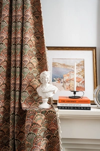 Detail of vintage thick jacquard curtain with multi-color fan patterns and white tassels