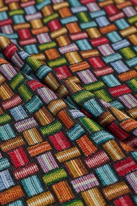 Close-up of geometric jacquard woven fabric with colorful pop art style patterns