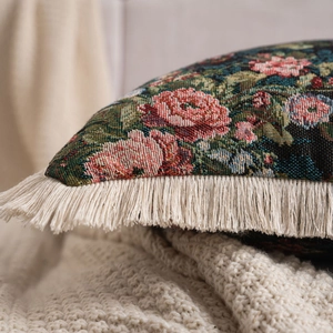 Detailed macro view of vintage jacquard fabric texture and off-white tassel fringe trim