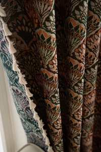 Detail of vintage floral jacquard fabric with thick texture and white tassel fringe
