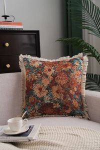 Macro shot of bohemian jacquard pillow texture with warm floral weave and fringe details
