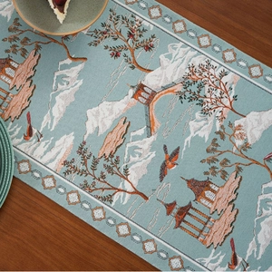 Chinese style table runner with mountain and pavilion jacquard on a wooden table