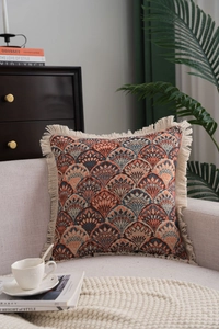 Close-up of bohemian throw pillow featuring jacquard fan patterns and handmade tassels
