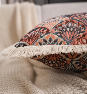 Close-up of geometric jacquard pattern and cream fringe details on ethnic pillow