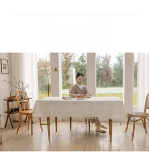 Detail of linen cotton rectangular tablecloth with elegant fringe and woven texture