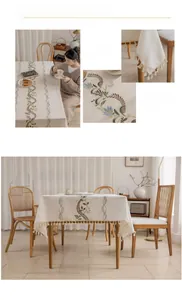 Close-up of brown spiral embroidery and fringe details on linen cotton tablecloth