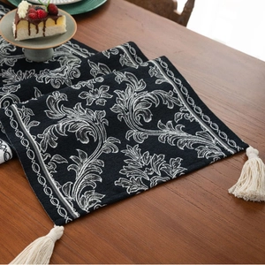 Elegant Zen-style black and white jacquard table runner with decorative tassels for dining room