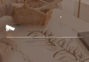 Close-up of retro floral embroidery on linen tablecloth with elegant fringe details