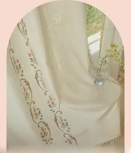 Detail of pastoral style curtains with floral embroidery and tassel fringe edges