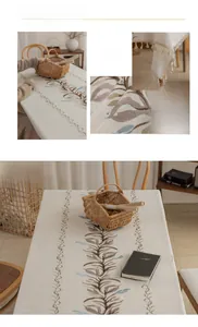 Detail of Nordic linen tablecloth with blue leaf embroidery and tassel edge decoration