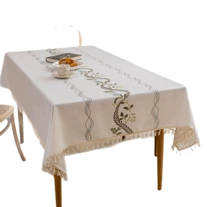Linen rectangle tablecloth with plant embroidery and tassels in a cozy home setting