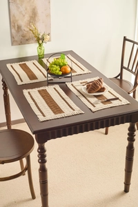 Set of four woven rectangle placemats with brown stripes and decorative fringe edges