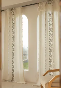Detail of floral embroidery and beige tassels on Nordic minimalist linen curtains