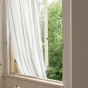 Semi-sheer white linen curtain with dark diamond embroidery and tassel fringe decor