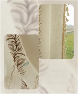 Detail showing leaf embroidery and decorative tassels on beige linen curtain fabric