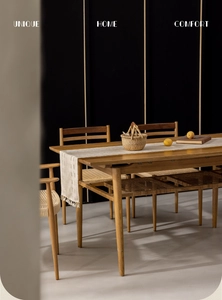 Close-up of cream table runner with elegant tassels on a minimalist wooden dining table