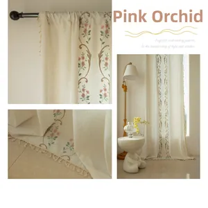 Detail of pink orchid embroidery and beige tassel edge on rural linen curtains
