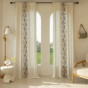 Detailed embroidery of brown and blue leaves on beige cotton linen curtains with tassels