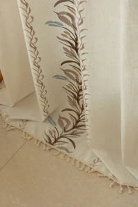 Detail of American country style beige linen curtain with leaf embroidery and fringe