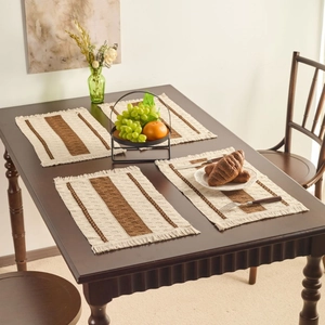 Set of four woven Nordic placemats with beige and brown stripes and elegant fringe