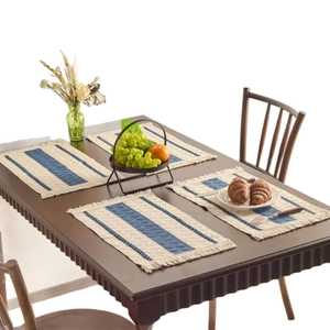 Set of 4 Nordic woven placemats with blue stripes and decorative tassels on wooden table