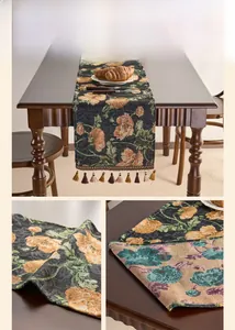 Close-up of geometric jacquard fabric table runner with intricate tassels on wood table