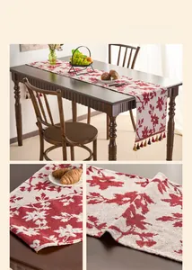 Detailed view of vintage red rose jacquard table runner with decorative tassels