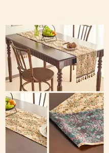 Close-up of orange plum blossom jacquard table runner with coffee tassels on cotton linen