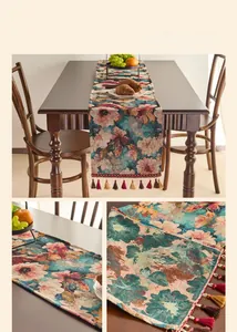 Detailed view of red and teal floral jacquard table runner with colorful fringe tassels