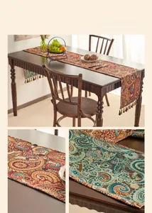 Close-up of vintage paisley jacquard table runner fabric with decorative tassels