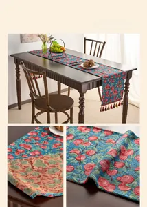Close-up of jacquard table runner featuring red cherry patterns and decorative tassels
