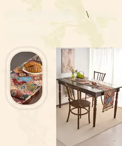 Detail of embroidered geometric patterns and decorative tassels on a woven table runner