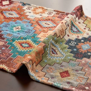 Ethnic geometric table runner with colorful diamond patterns and woven texture details
