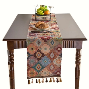 Ethnic bohemian table runner with orange geometric diamond patterns and fringe tassels