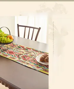 Close-up of geometric jacquard table runner with colorful fringe on wooden table