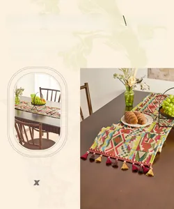 Close-up of geometric jacquard table runner featuring multi-colored handmade tassels