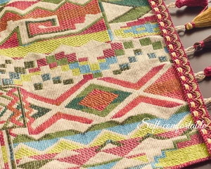 Close-up of geometric jacquard ethnic table runner with tassels and woven patterns