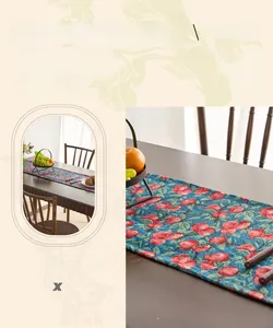 Close-up of yarn-dyed cotton linen fabric with red fruit and green leaf jacquard patterns