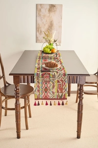 Close-up of geometric jacquard table runner featuring colorful fringe and woven texture
