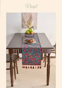 Detail of American country style table runner with red cherry jacquard and tassels