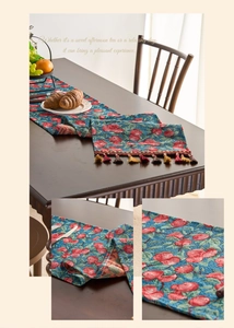 Detail of red cherry jacquard table runner with decorative tassels and textured fabric