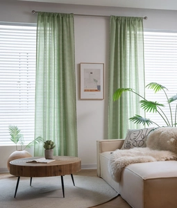 Sage green semi-sheer floral curtains with linen texture on silver metal rod