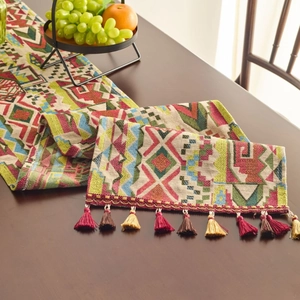 Ethnic bohemian table runner with colorful geometric jacquard and handmade tassel trim