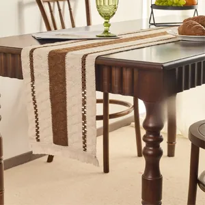 Detailed view of Nordic cotton linen table runner with brown stripes and fringe