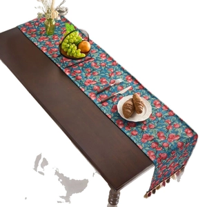 American farmhouse table runner with red cherry jacquard pattern and colorful fringe
