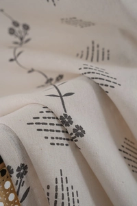 Detailed macro shot showing cotton linen texture and floral print of Nordic curtains