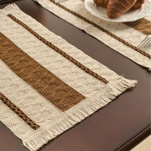 Bohemian style striped table runner with tassels on a dark wood dining table