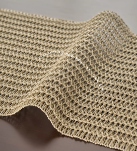 Detail of green hollow mesh woven table runner showing lightweight and foldable texture